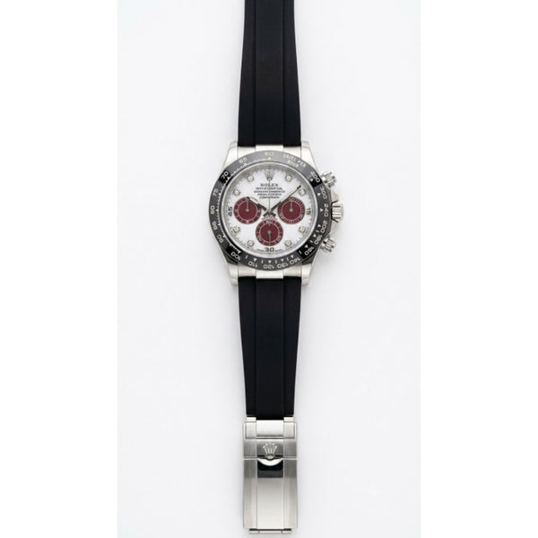 Roleex Cosmograph Daytona chronograph white-and-red dial paired with a black rubber strap